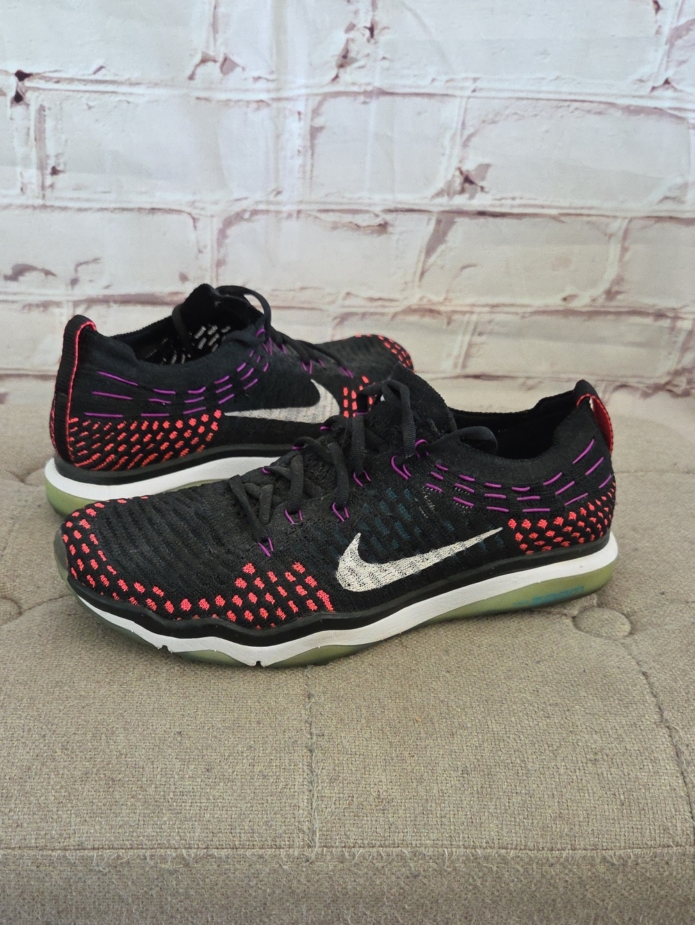 Nike Women’s Black Flyknit Athletic Shoes with Pink and Purple Stitching